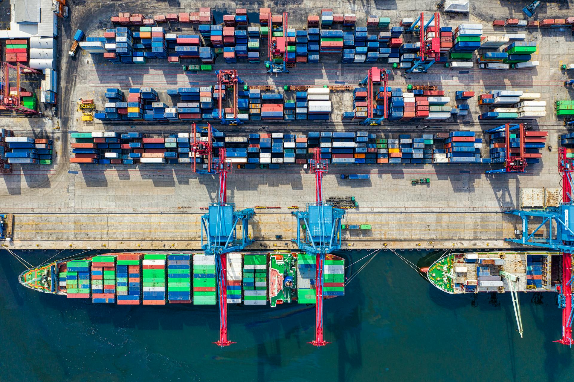 Container ship loaded with colourful shipping containers at port terminal